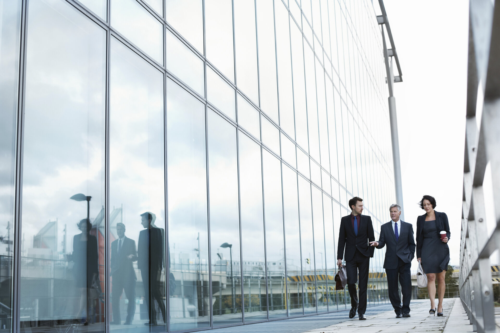 people walking by office building