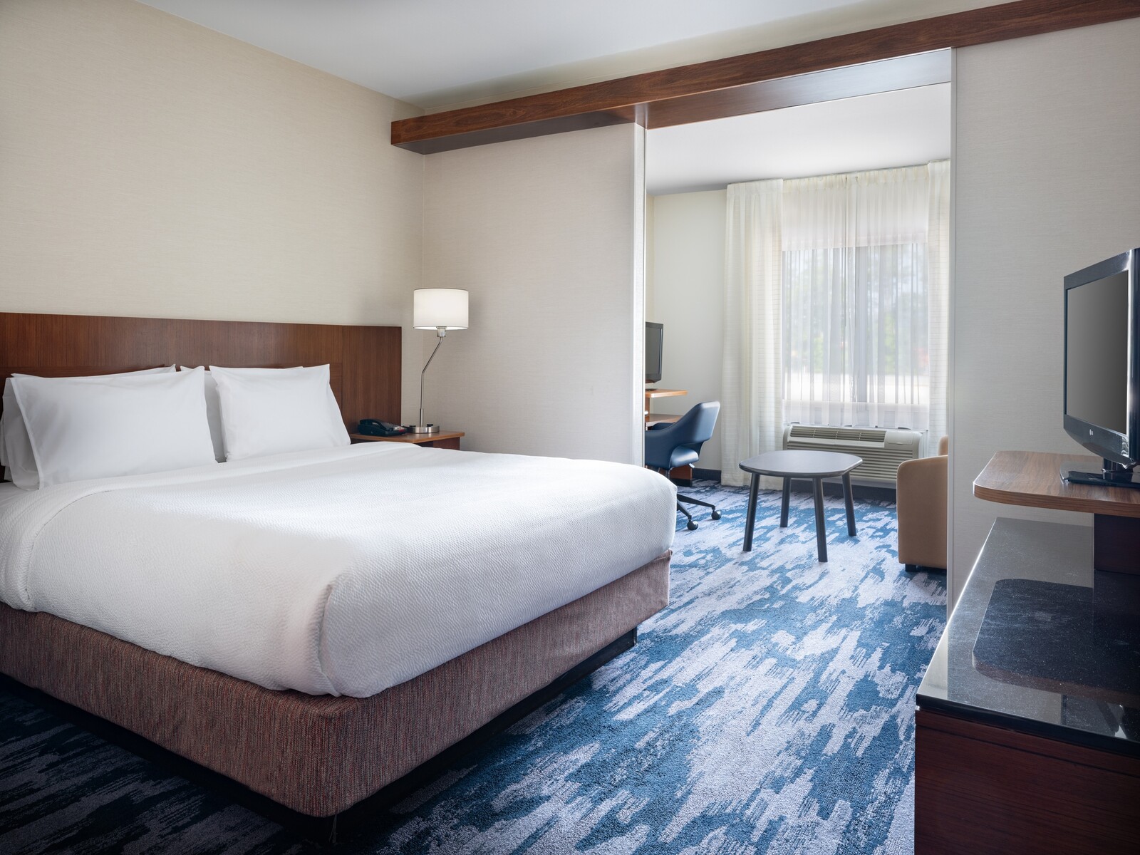 a hotel room with a bed and a desk