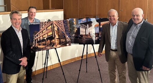 a man standing next to a picture of a building