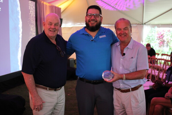 a group of men standing together and smiling
