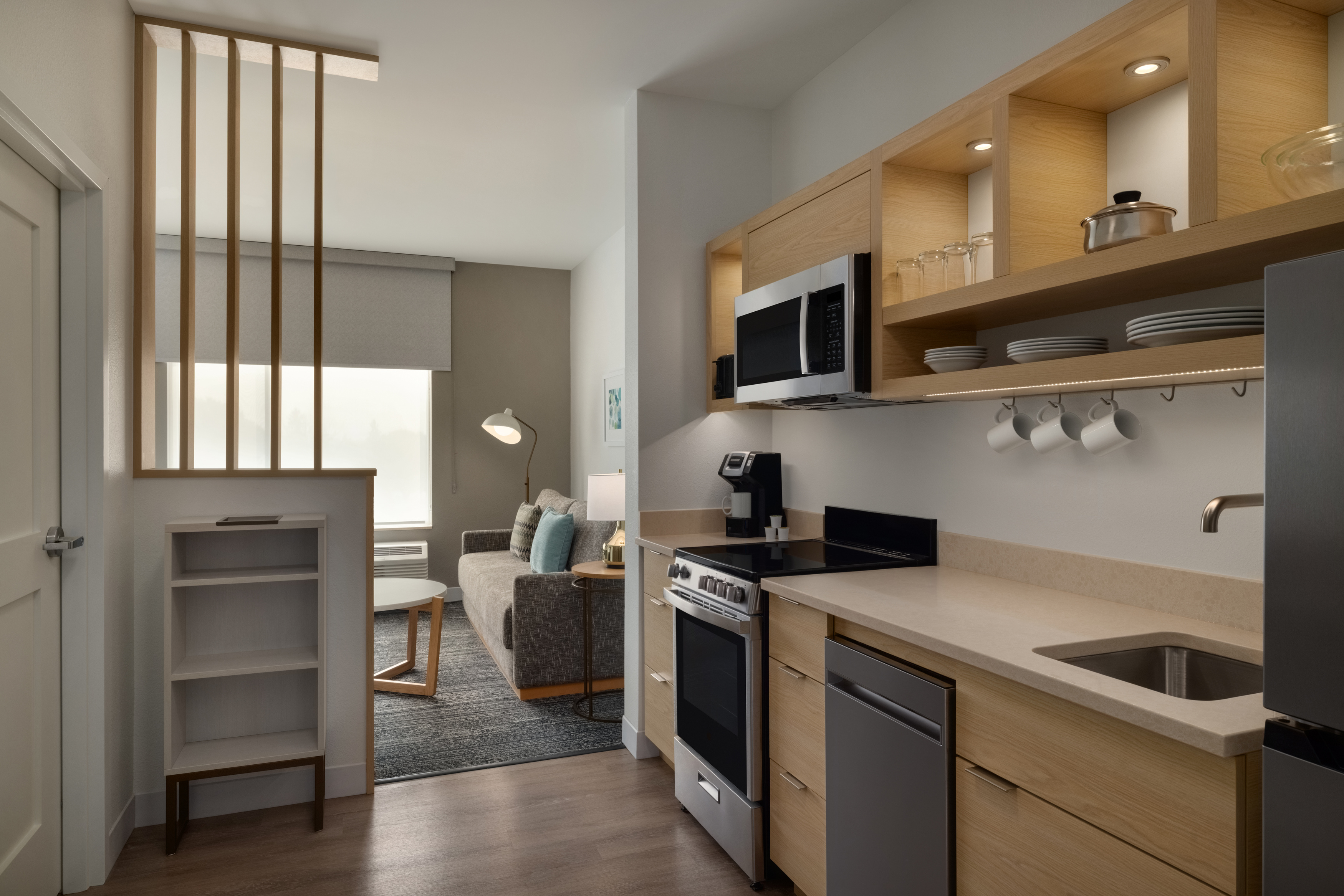 a kitchen with wood cabinets and a couch