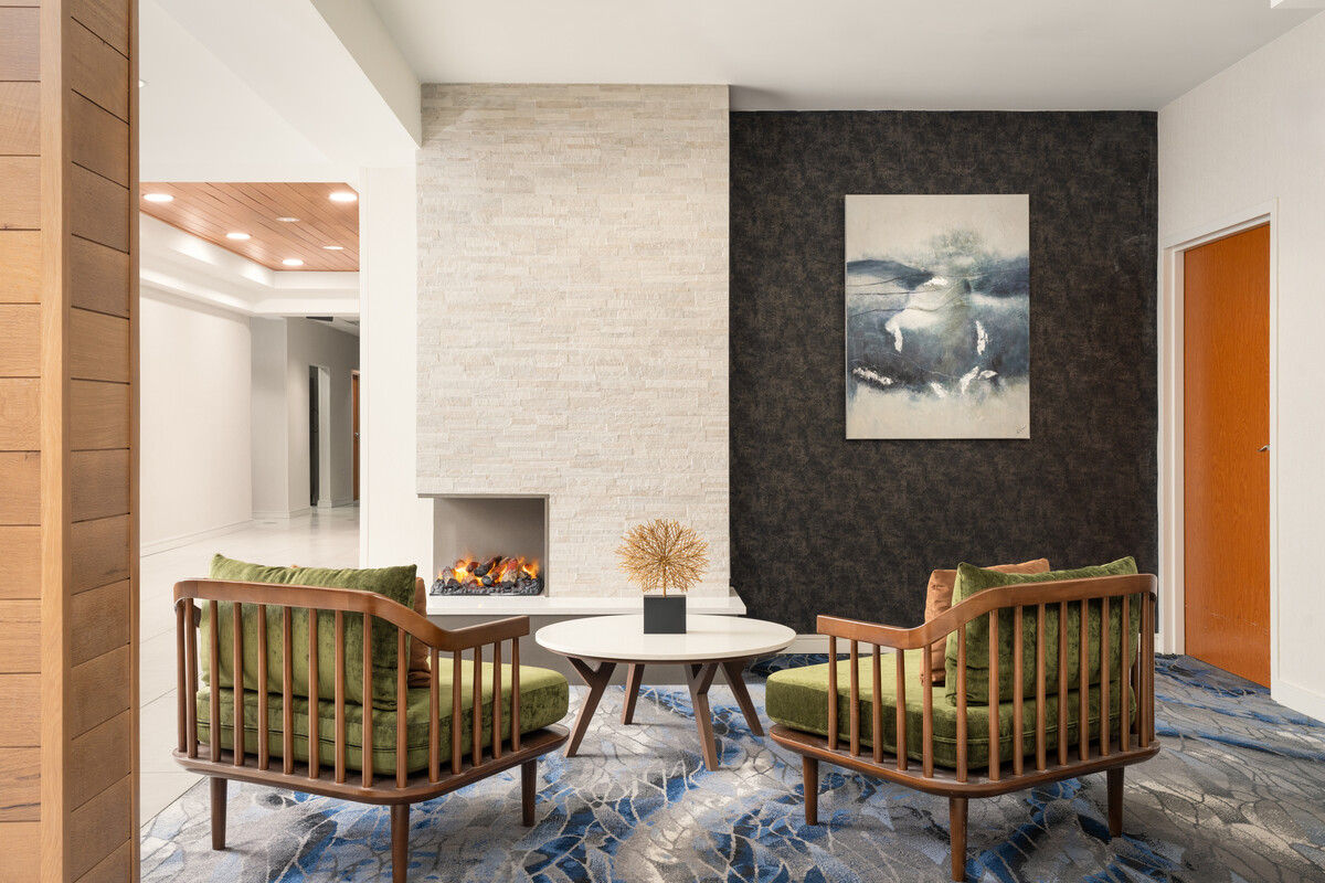 a room with a fireplace and chairs