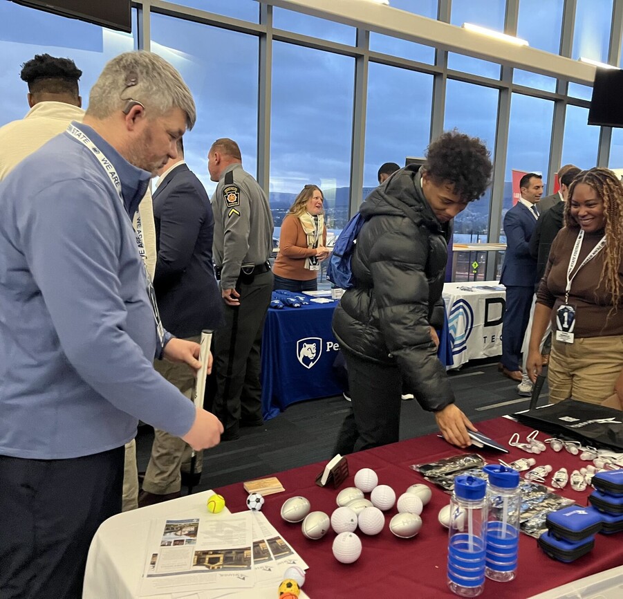 people looking at a booth set up at a PSU networking event