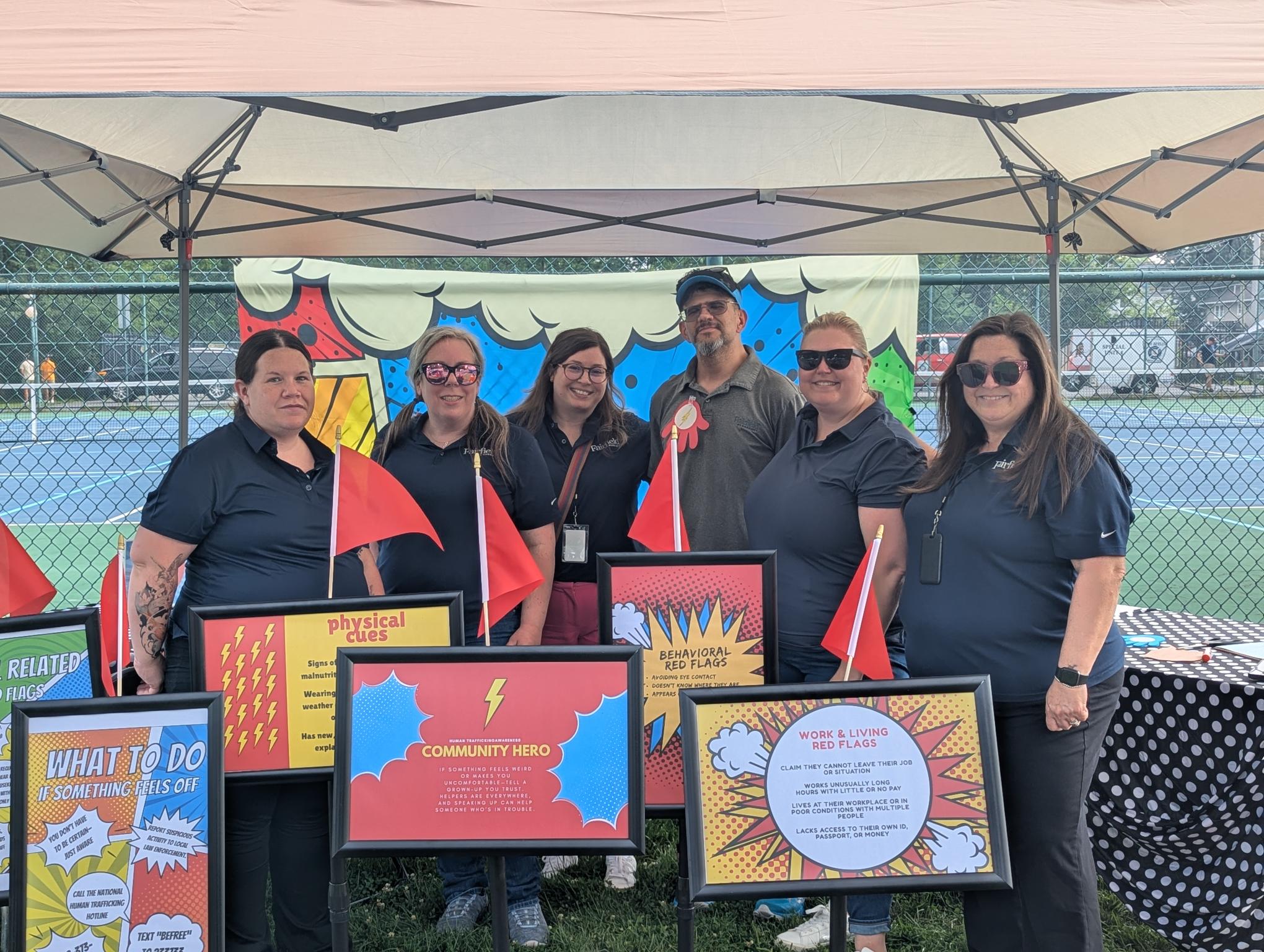 Group photo of staff volunteering at a community event 