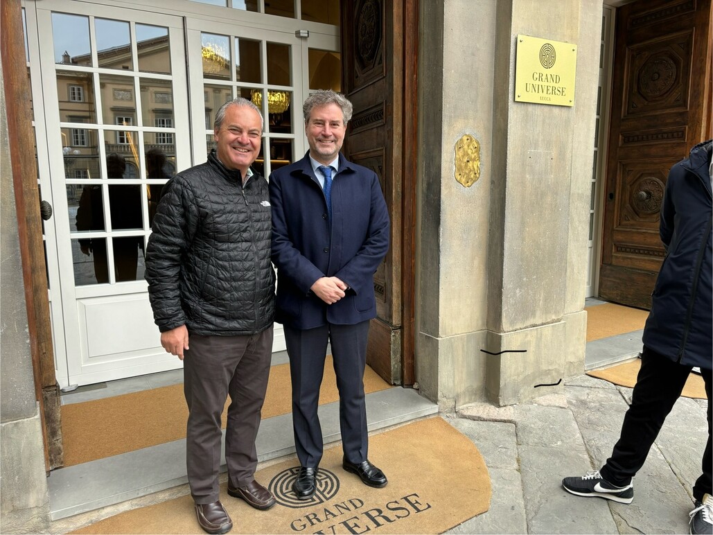 men standing in front of Grand Univers Lucca hotel