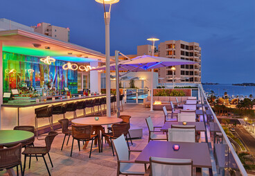 a patio with tables and chairs