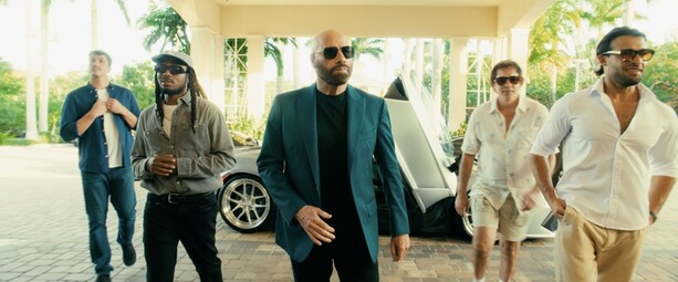 a man in a suit and sunglasses