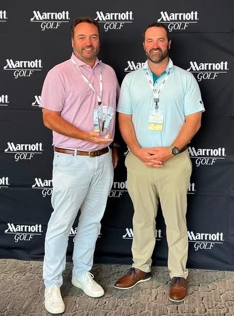 Steve and Tyler holding the Marriott Golf course Award